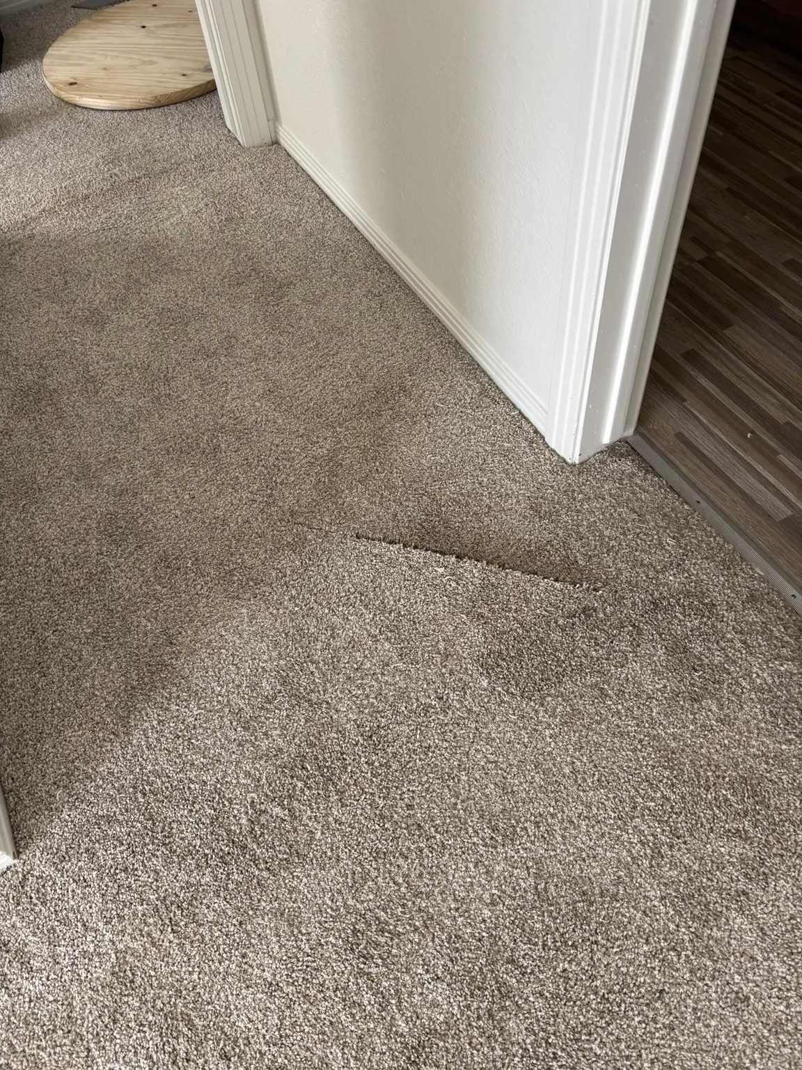 Carpet damage left by another contractor before professional repair